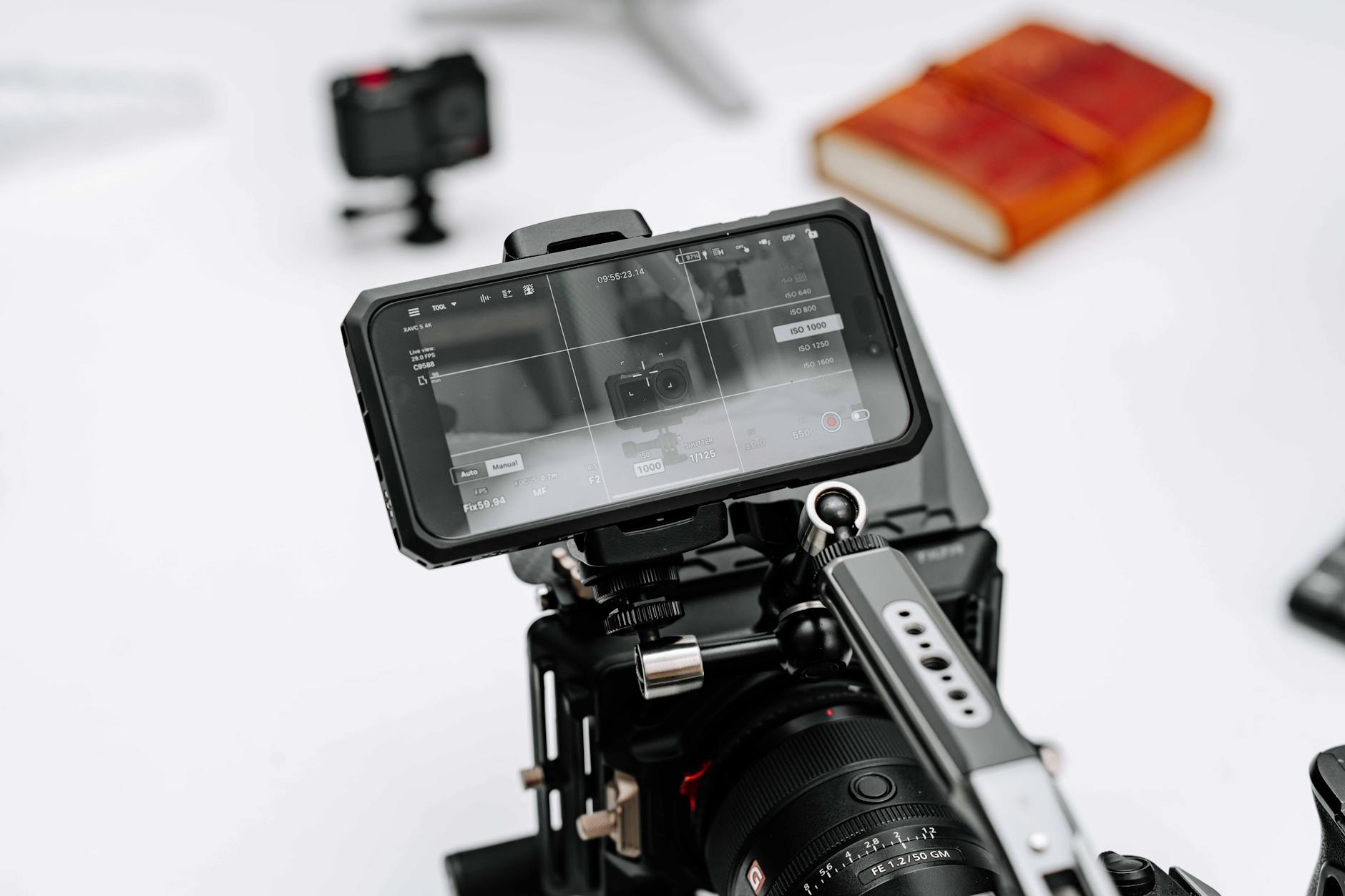 Close-up of a professional camera rig with monitor display in a studio setting, ideal for filmmaking.